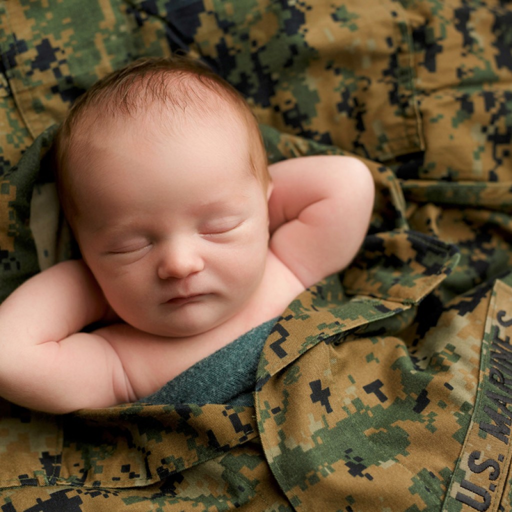 Baby photography that showcases sweet baby boy with his daddy's fatigues. Marine baby photographer in San Marcos ca